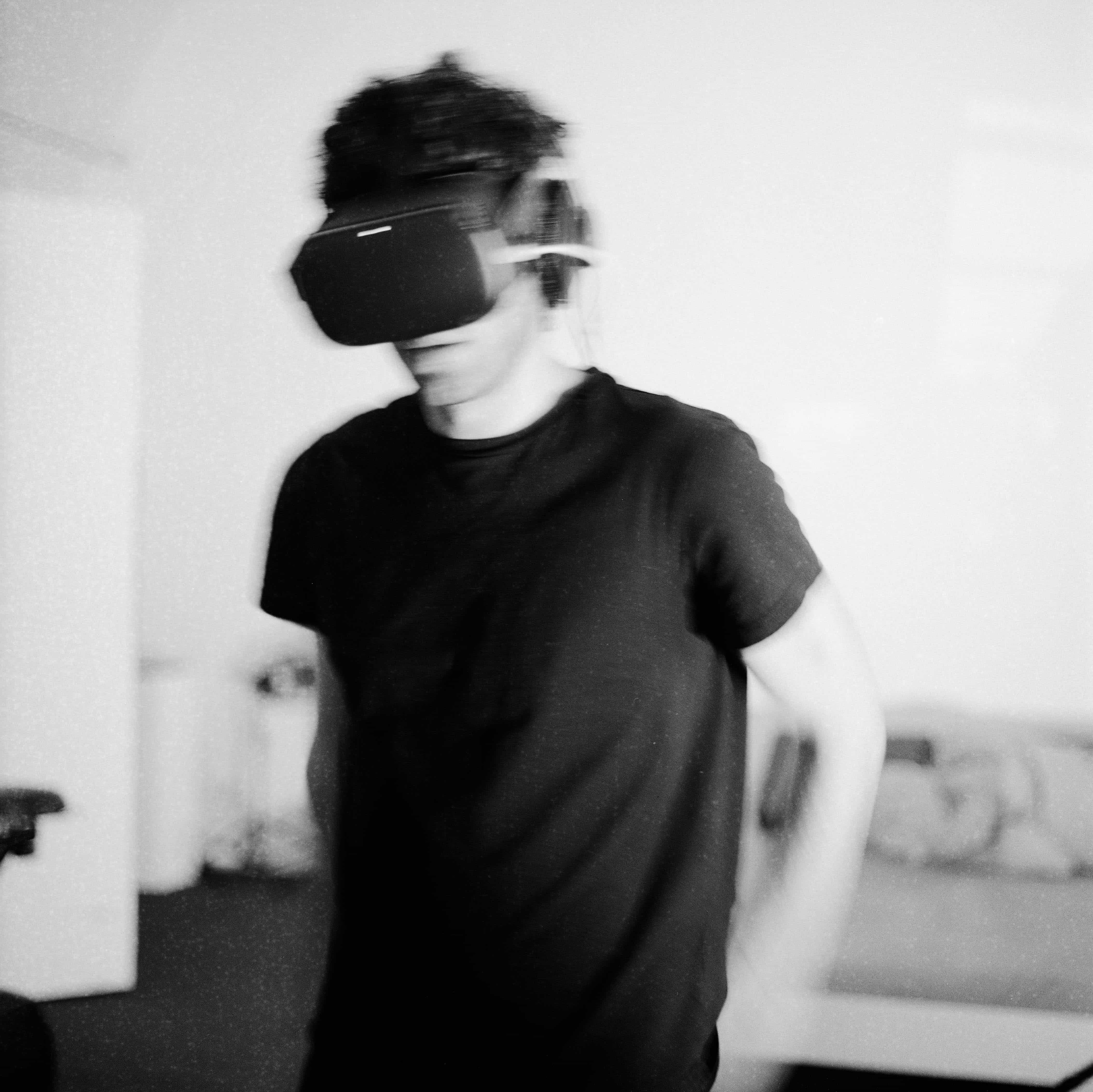 The artist with the VR headset on, walking around.